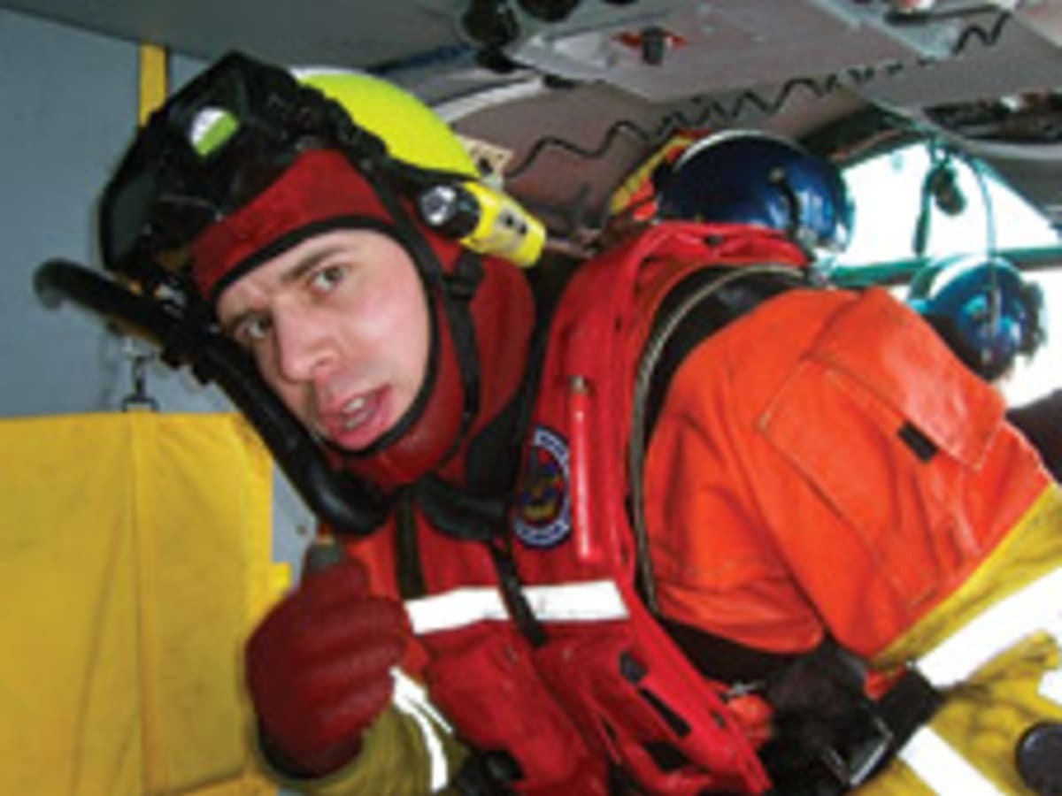 Rescue swimmer, Petty Officer 3rd Class Abram Heller, in dry suit aboard a Coast Guard rescue helicopter. (U.S. Coast Guard) Rescue swimmer, Petty Officer 3rd Class Abram Heller, in dry suit aboard a Coast Guard rescue helicopter. (U.S. Coast Guard)