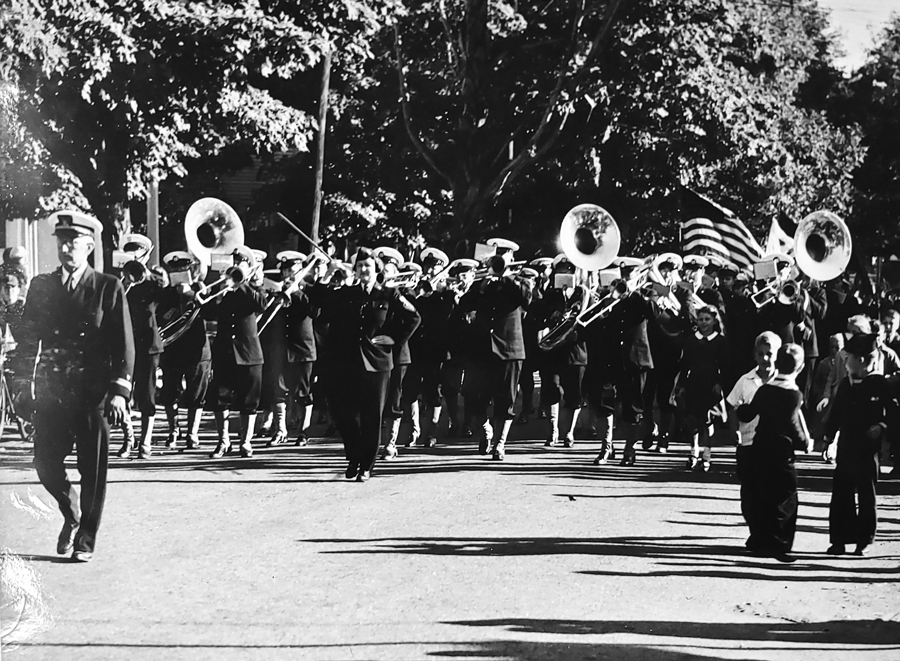 Image of Dot Slamin serving as remporary reserve bandmaster. She’s marking front and center of the band with the baton in her right hand. (Dot Slamin Collection at the Waltham Historical Society)