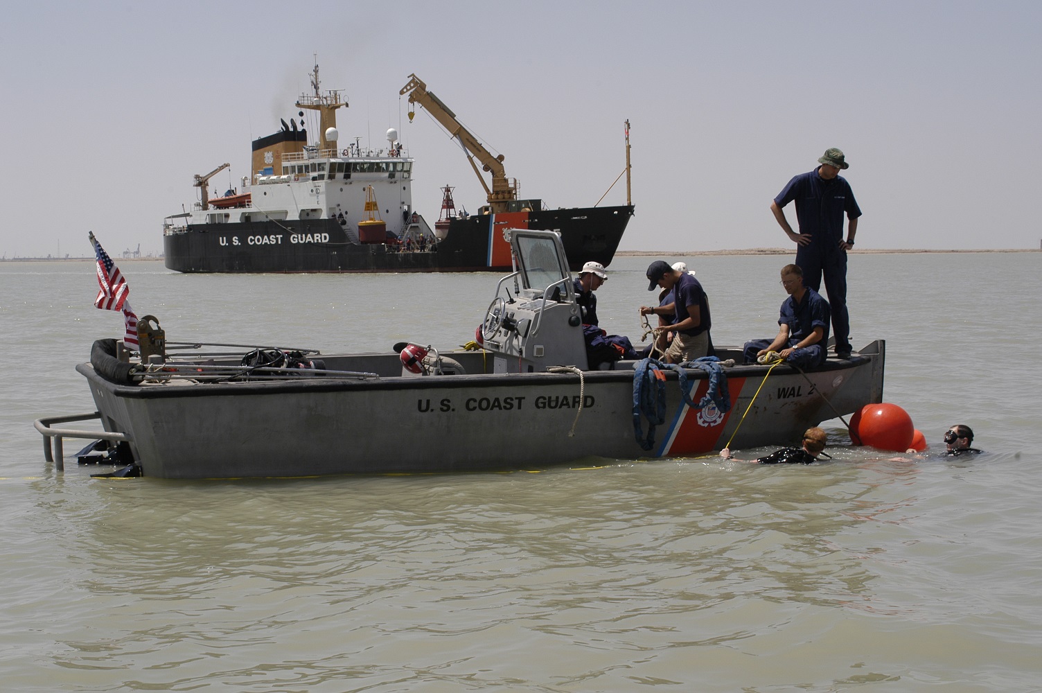 Divers work from a Coast Guard smallboat supporting Coast Guard Cutter Walnut’s aids-to-navigation operations. (Coast Guard Collection)