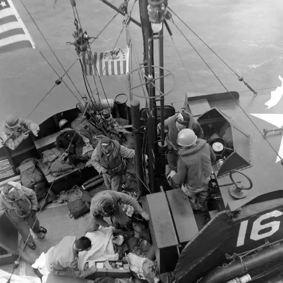 Photo of CG-16 crew evacuating rescue victims to the USS Joseph T. Dickman on D-Day. (Life Archives, Ralph Morse Photographer)