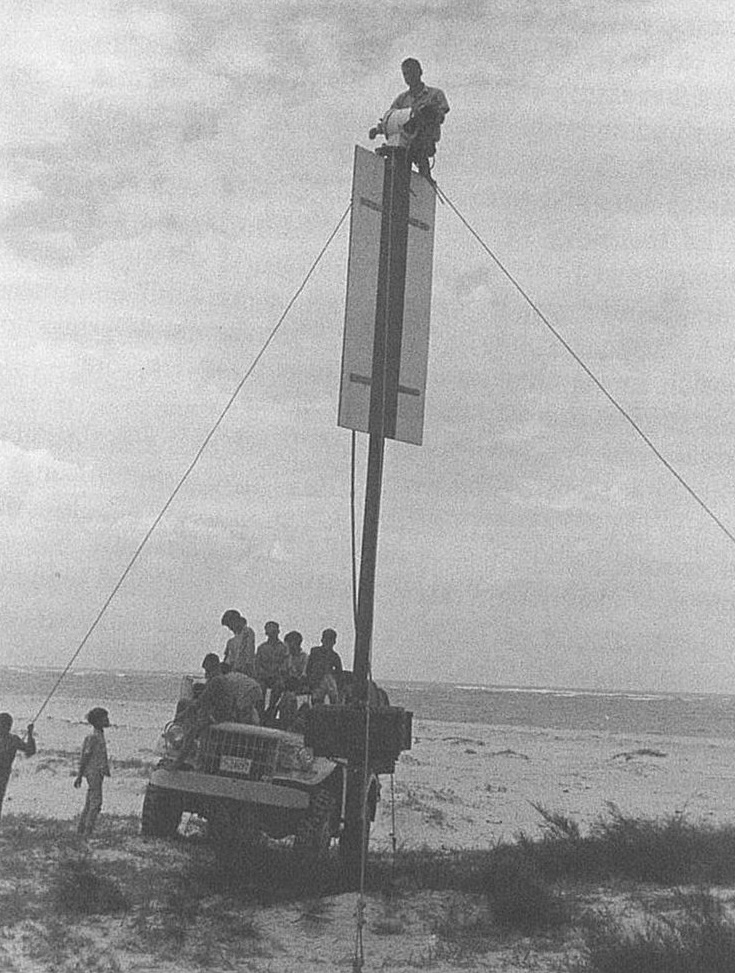 A Coast Guard aids-to-navigation expert works on a range marker for ship navigation in Vietnam. (U.S. Coast Guard)