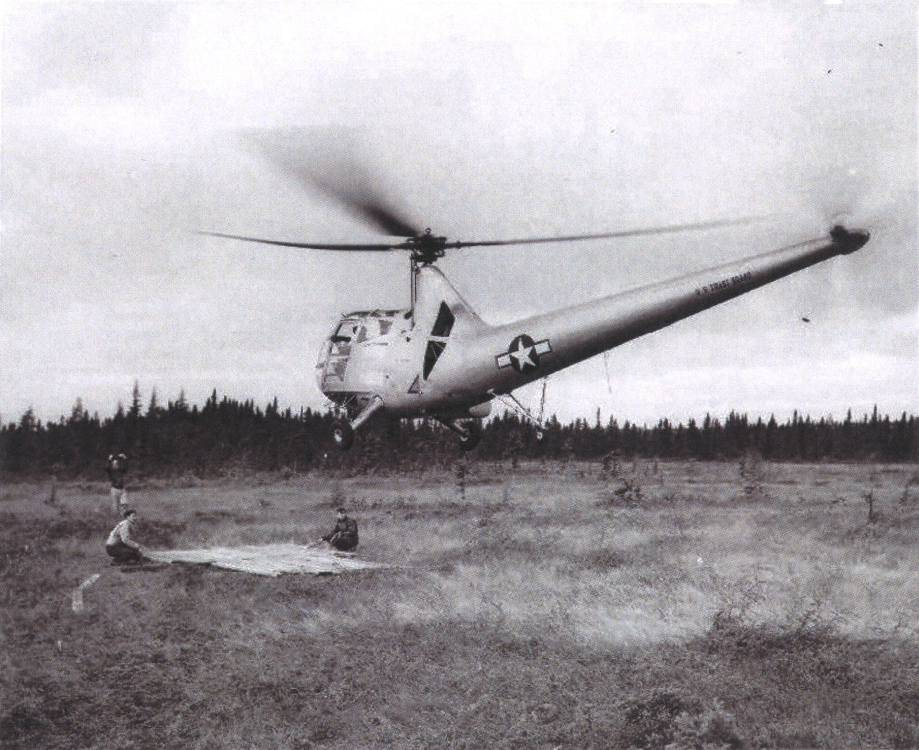 A Coast Guard Sikorsky HOS-1 landing on a makeshift landing pad placed on the soft muskeg near the crash site. (U.S. Coast Guard)