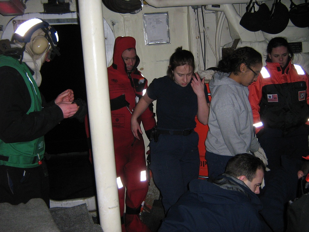 Munro crewmembers treating survivors of Fishing Vessel Alaska Ranger for hypothermia in Munro’s galley. (Ensign Daniel Schrader, U.S. Coast Guard)