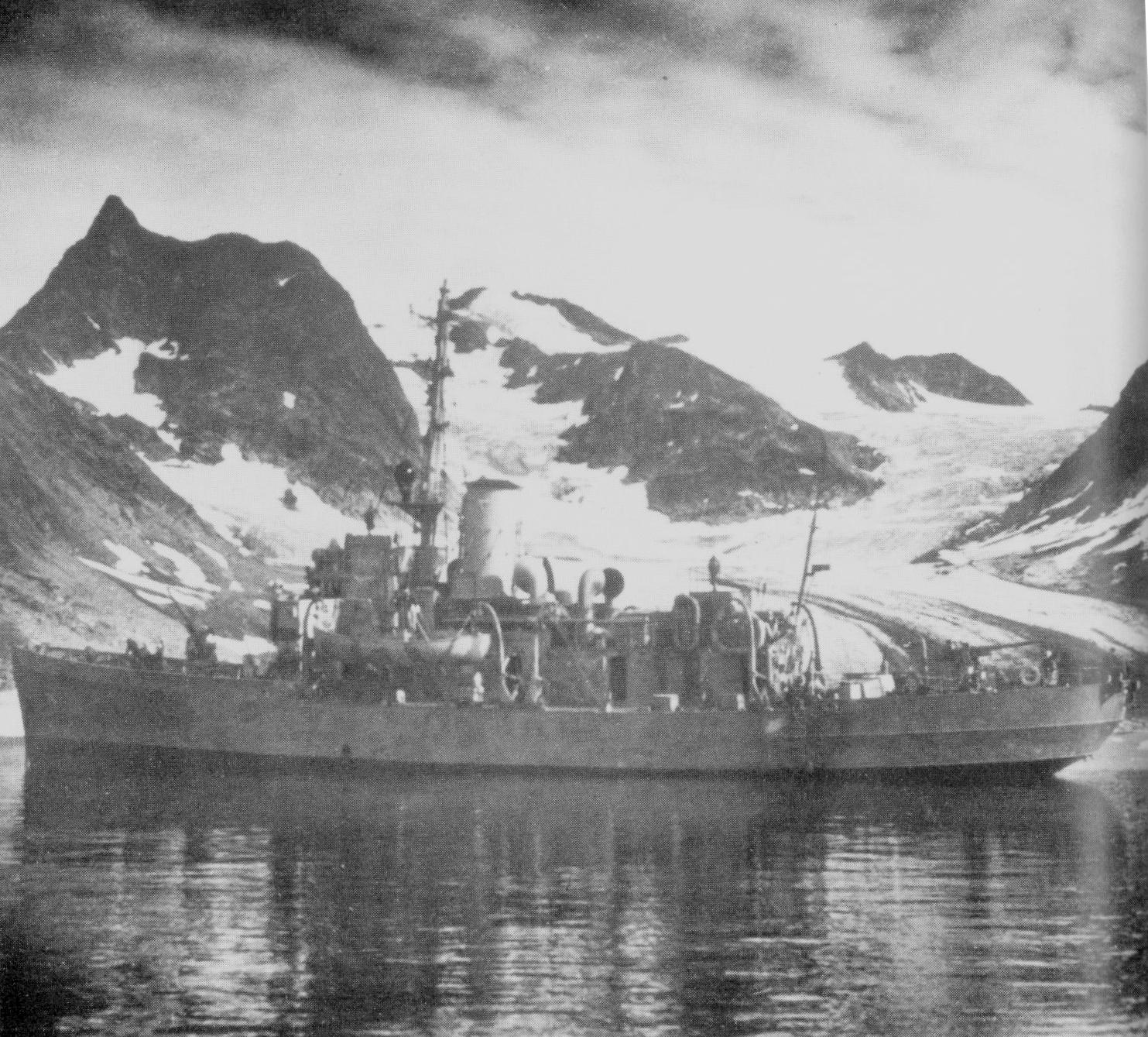 Coast Guard Cutter Comanche in wartime paint scheme with the high peaks of Greenland in the background. (U.S. Coast Guard)