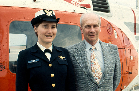 9.	Newly winged Ensign Janna Lambine standing in front of a Coast Guard helicopter with her father. (U.S. Coast Guard)