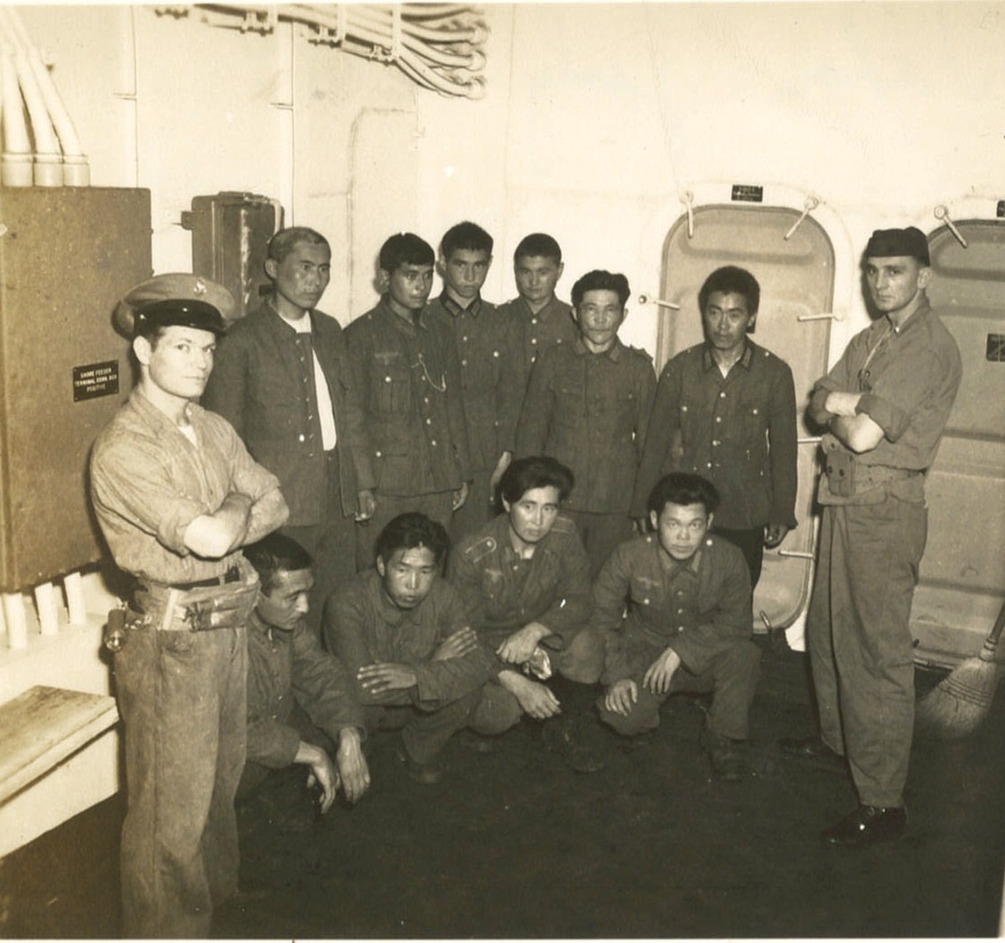 9.	Chief Manges standing with Korean conscripts in the German Army captured during the D-Day invasion. (Courtesy of Robert Manges)