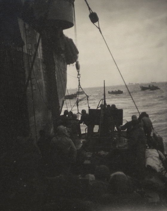 Transferring victims from CG-16’s fantail to the USS Joseph T. Dickman for medical treatment with landing craft assembled in the background. (Courtesy of Hannigan family)