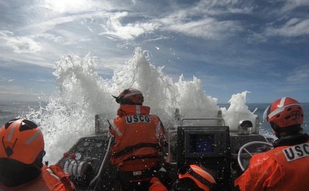 Petty Officer 1st Class Victoria Hansen (right), Surfman #484 and an instructor at the National Motor Life Boat School in Ilwaco, Washington, operates a 47-foot Motor Life Boat in 2019 while training at Benson Beach near Cape Disappointment. Hansen is qualified to operate the rescue boats in seas up to 30 feet and in more than 50 mph winds. U.S. Coast Guard photo provided by Petty Officer 1st Class Victoria Hansen.