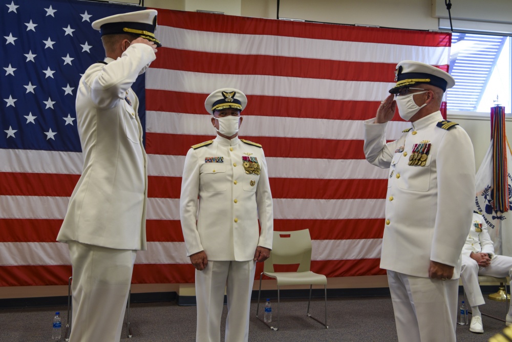 Cmdr. Eric Cain, right, assumes command of Base Galveston from Capt. Jason Smith, left, commander, Coast Guard Sector Houston-Galveston, during Base Galveston’s establishment ceremony Sept. 29, 2020, in Galveston Texas. The ceremony was presided over by Rear Adm. Melvin W. Bouboulis, Director of Operational Logistics. (U.S. Coast Guard photo by Petty Officer 2nd Class Ryan Dickinson)