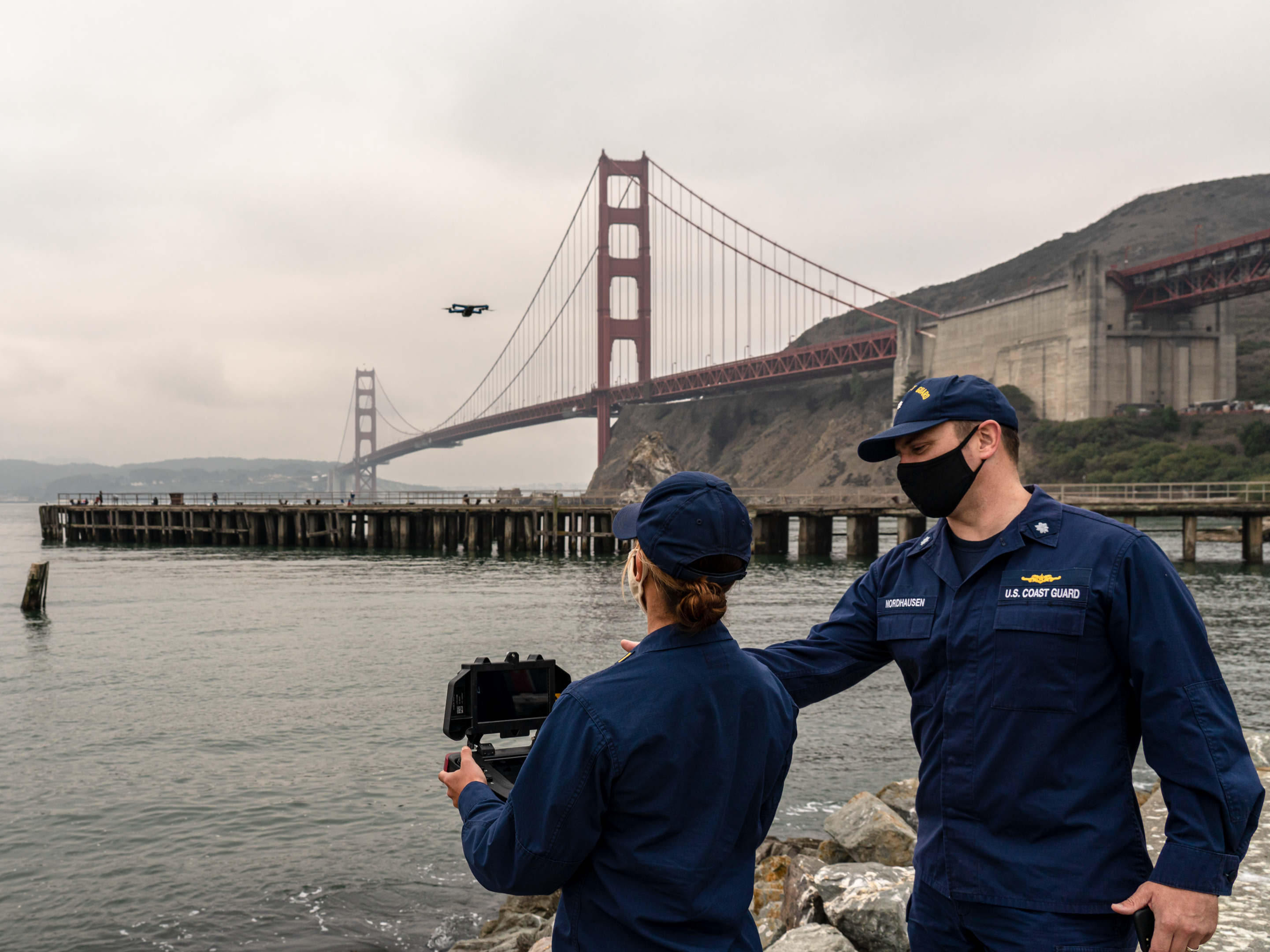 Defense Innovation Unit liaison Cmdr. Michael Nordhausen and Ensign Sarah Levesque, a Coast Guard certified drone operator from the Sector San Francisco Enforcement Division, conduct evaluations of blue small unmanned aircraft system technology. Photo courtesy of Defense Innovation Unit.