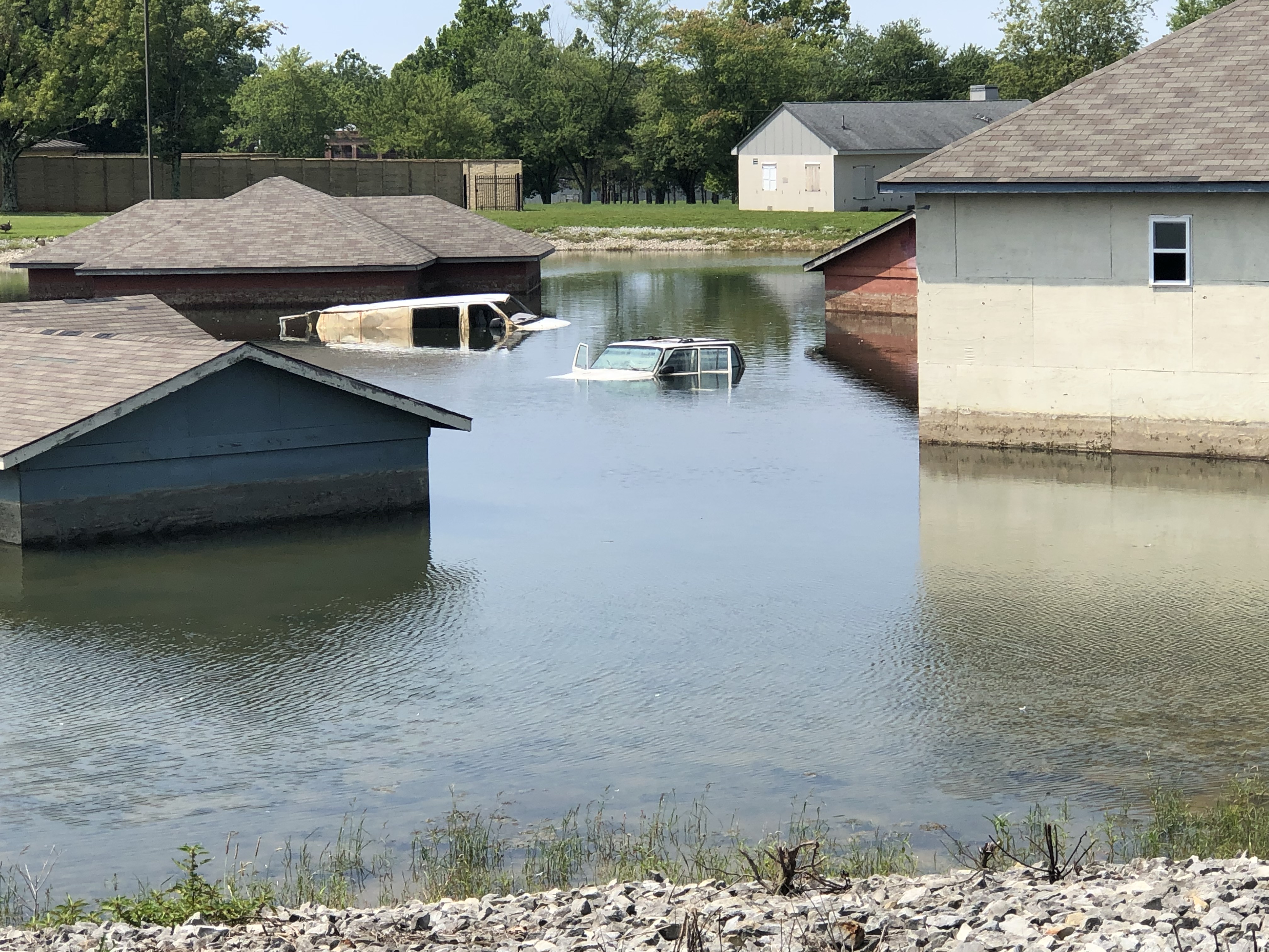 BUTLERVILLE, IN - A glimpse of the flooded town that Coast Guard members walked into early this August. Pictured is the Muscatatuck Urban Training Center (MUTC)’s flooded village, which includes flooded houses, vehicles, and street signs, awaits members who will use this environment to train for missions such as rescuing survivors from rooftops. 