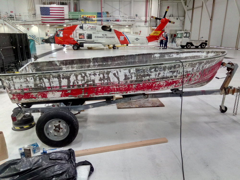 BEFORE: A 12-foot johnboat on a trailer in the hangar at Coast Guard Air Station Sitka in the summer of 2020