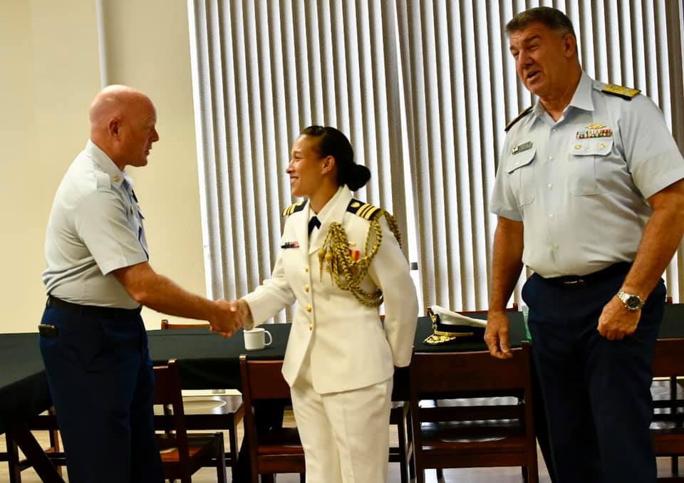 Lt. Cmdr. Dykeman, of Sector Los Angeles - Long Beach, California shakes hands with Master Chief Petty Officer of the Coast Guard Jason M. Vanderhaden after receiving the Captain John G. Witherspoon Inspirational Leadership Award, July 2, 2021. Coast Guard Commandant, Adm. Karl Schultz, also congratulated Dykeman. U.S. Coast Guard Academy photo  