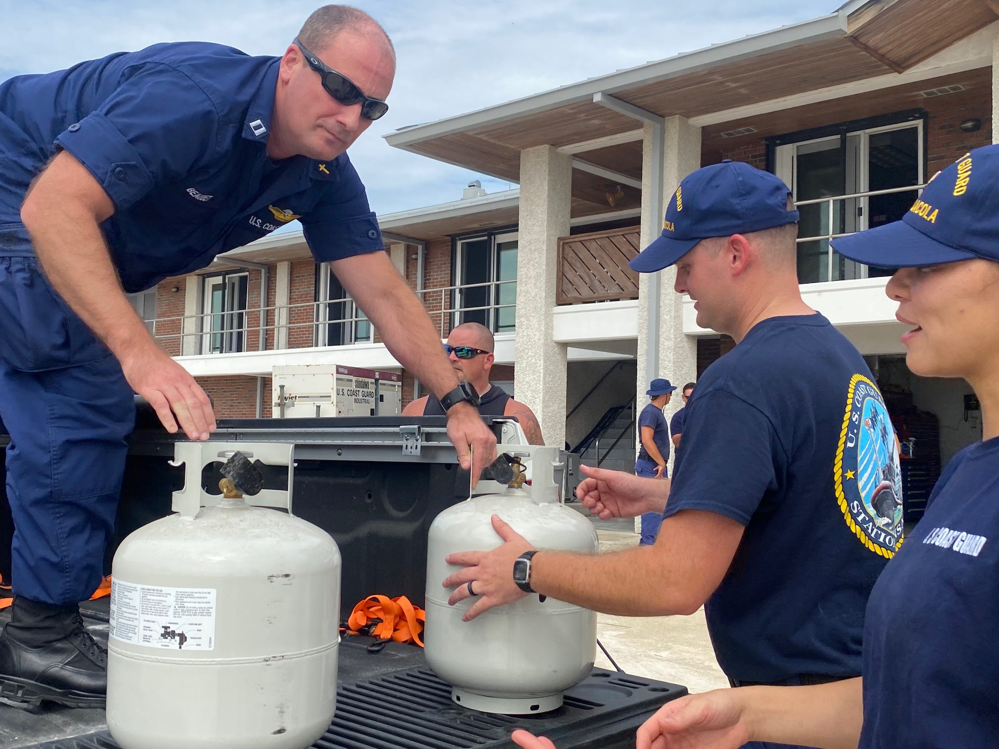 Command Master Chief Zachary Ayres, Chaplains Lt. Mark Beaudet and Lt. Doyle Allen, all of Sector Mobile, provided meals ready to eat (MRE), water bottles, and propane tanks to Coast Guard Station Pensacola after the unit was damaged and lost power during Hurricane Sally, Sept. 18, 2020.