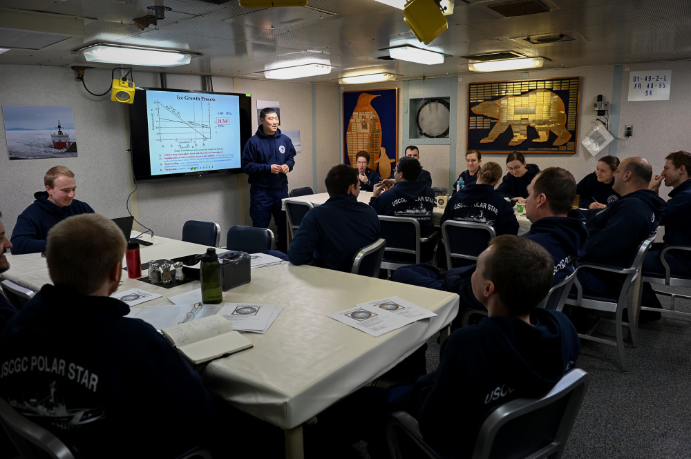 Lt. Cmdr. Andrew Jantzen, the operations officer aboard the Coast Guard Cutter Polar Star (WAGB 10), holds ice pilot training in the cutter's wardroom Monday, December 14, 2020 while underway in the Bering Sea. U.S. Coast Guard Photo by Petty Officer 1st Class Cynthia Oldham 