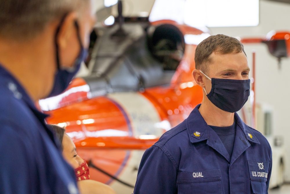 Adm. Karl Schultz, the commandant of the Coast Guard, informs Petty Officer 1st Class Wallace Qual he will be meritoriously advanced to petty officer 1st class at Coast Guard Sector North Bend August 20, 2020. In attendance to the advancement ceremony were Qual’s family, Master Chief Petty Officer Jason Vanderhaden, the master chief petty officer of the Coast Guard, and others. (U.S. Coast Guard photo by Petty Officer 2nd Class Travis Magee/Released)