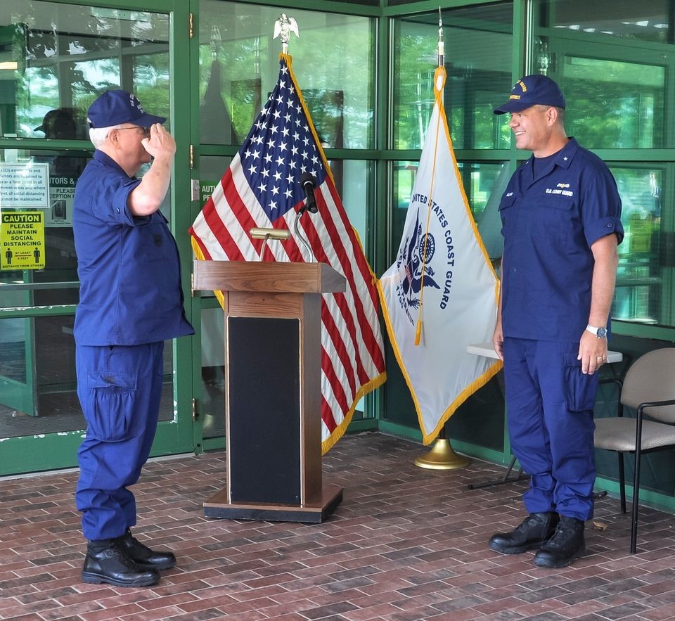 NEW LONDON, Conn. – William Bowen (left), commodore of the Auxiliary’s First District, Southern Region, salutes Rear Adm. Tom Allan (right), who First Coast Guard District commander presides over the stand-up of the new unit, Aug. 26, 2020. Both expressed great excitement at the prospects this first-of-its-kind unit will bring to the Coast Guard’s RDC. (U.S. Coast Guard photo.)