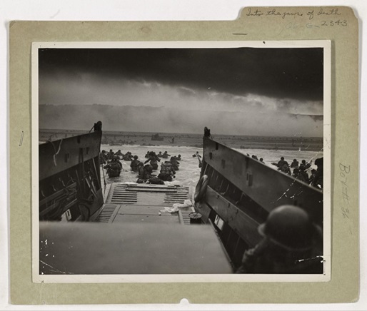 4.	Down the ramp of a Coast Guard landing barge Yankee soldiers storm toward the beach-sweeping fire of Nazi defenders in the D-Day invasion of the French Coast. Troops ahead may be seen lying flat under the deadly machinegun resistance of the Germans. Soon the Nazis were driven back under the overwhelming invasion forces thrown in from Coast Guard and Navy amphibious craft. (NARA)