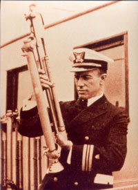 4)	Lieutenant Edward “Iceberg” Smith with a Green-Bigalow bottle. (Coast Guard photo)