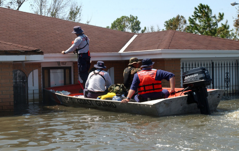 Members of the Coast Guard Sector Ohio Valley Disaster Response Team and the Miami-Dade Urban Search and Rescue Team mark a house here today to show that it has been searched for survivors of Hurricane Katrina. Teams are conducting massive search efforts for anyone who may still be trapped by the floodwaters. USCG photo by PO Robert Reed.