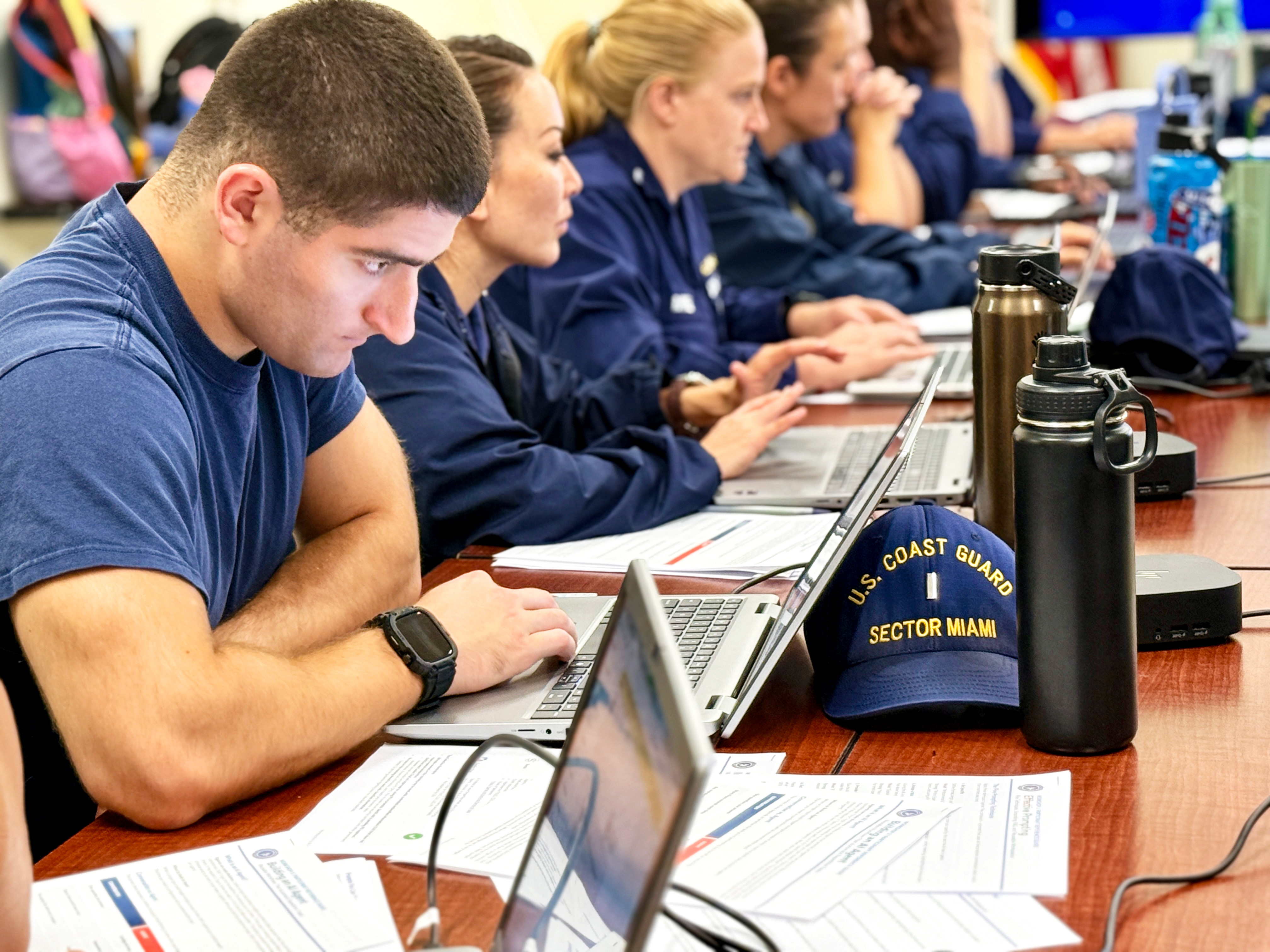 Coast Guard men and women from Sector Miami practice using AI tools during a training session June 2, 2026. The training was part of the Technology Readiness Directorate (CG-TECH) Workforce Engagement Tour visit to Miami, the first in a series designed to bring digital transformation to the deckplate across the Coast Guard.
