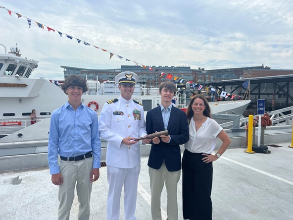 4.	LCDR Brent Lane holds the CGC William Chadwick’s Long Glass with Ms. Meredith Dignan, and her family during William Chadwick’s first Change of Command Ceremony. (Courtesy of author)